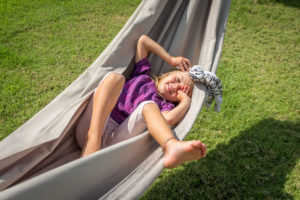 Child relaxing in a hammock on vacation at Citakara Sari Estate